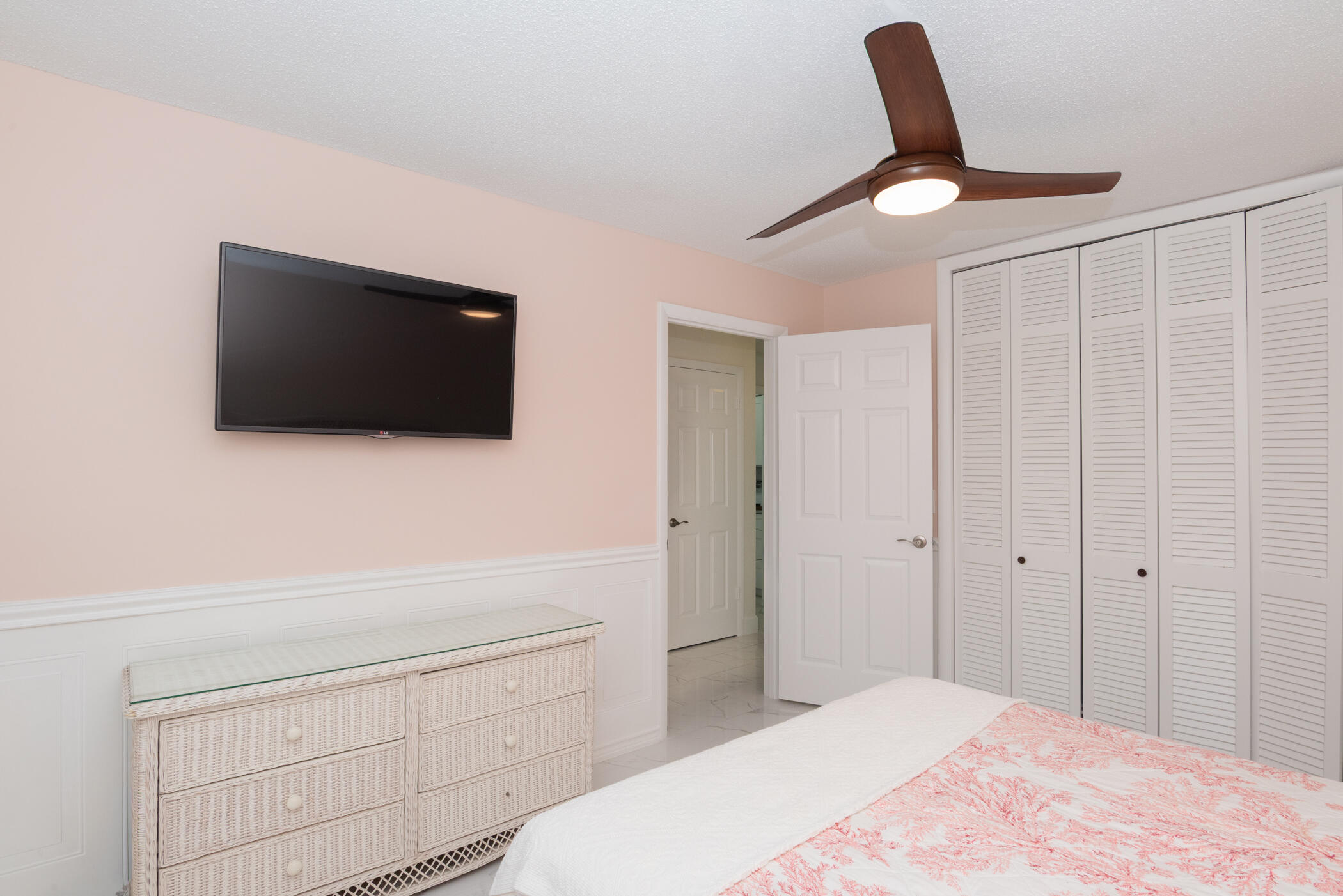 2811 Southeast Fairway West Stuart, FL 34997 - Photo 28 of 40 a bedroom with a bed and a flat screen tv