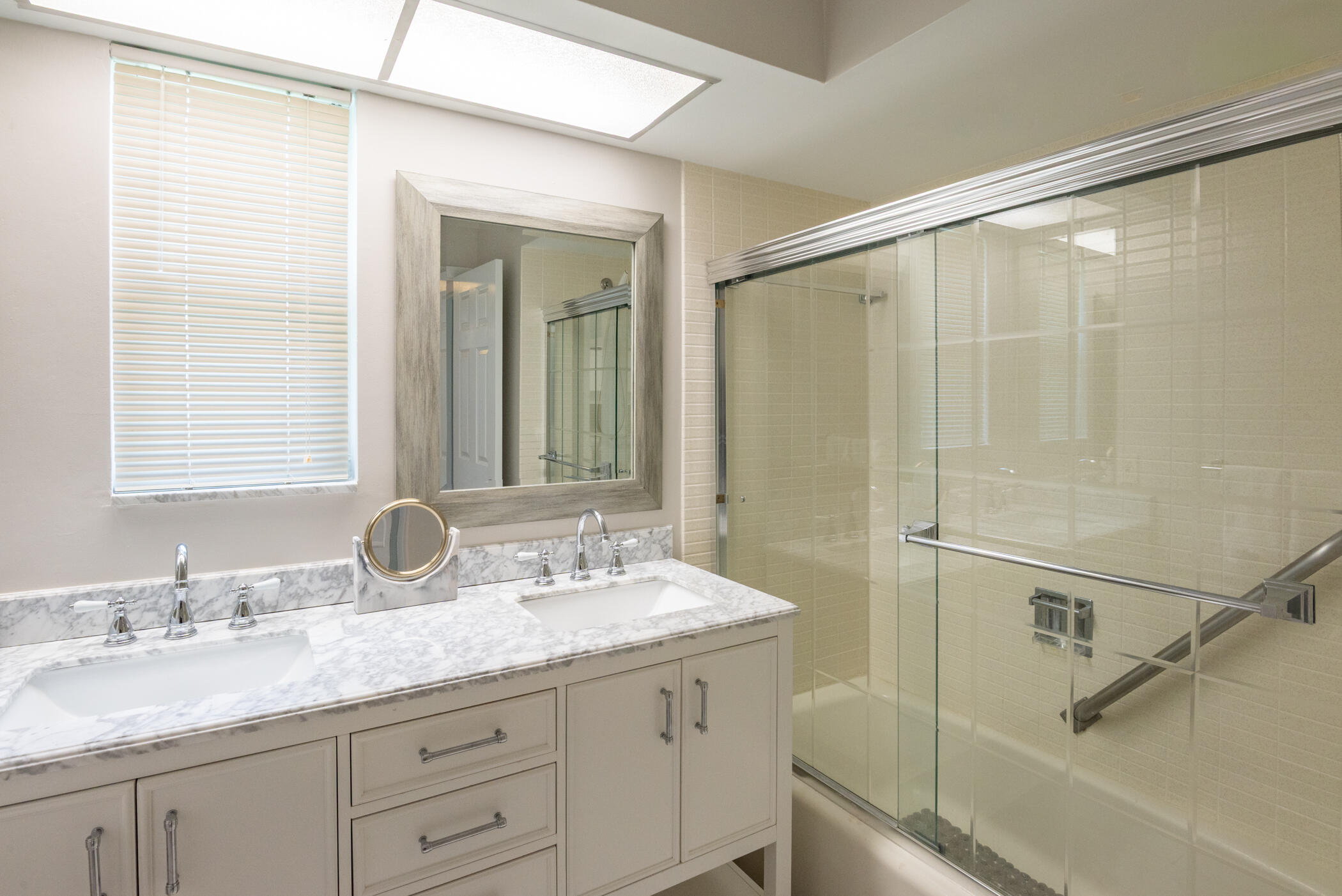 2811 Southeast Fairway West Stuart, FL 34997 - Photo 29 of 40 a bathroom with a granite countertop sink mirror and a shower