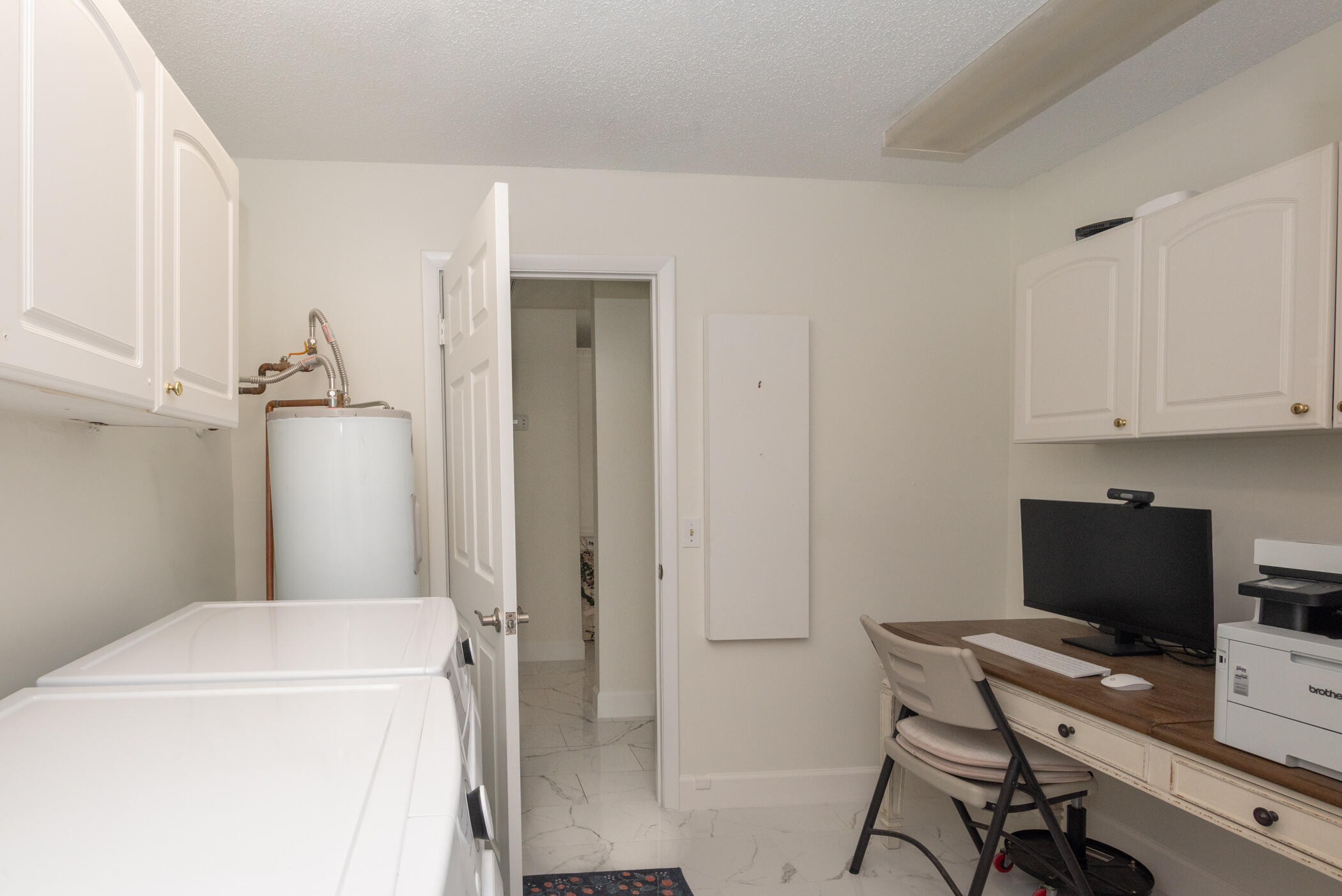 2811 Southeast Fairway West Stuart, FL 34997 - Photo 30 of 40 a view of a workspace with furniture and a gate