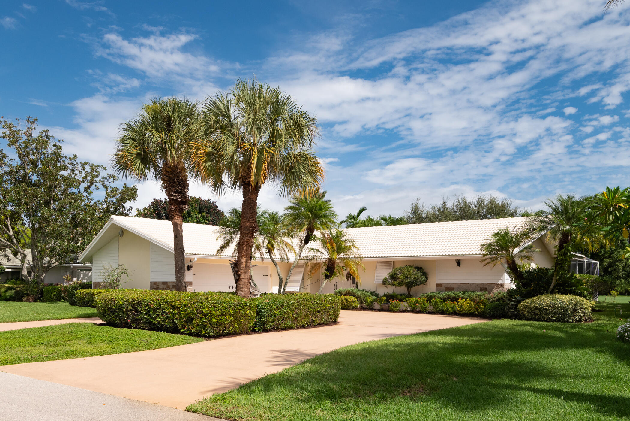 2811 Southeast Fairway West Stuart, FL 34997 - Photo 5 of 40 a front view of a house with a yard and garage