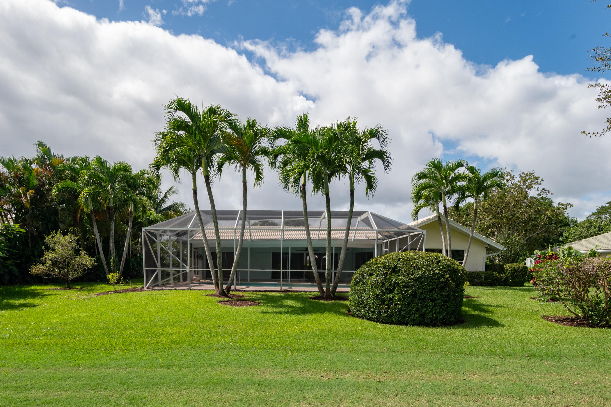 2811 Southeast Fairway West Stuart, FL 34997 - Photo 7 of 40 a view of a swimming pool and trees in the background
