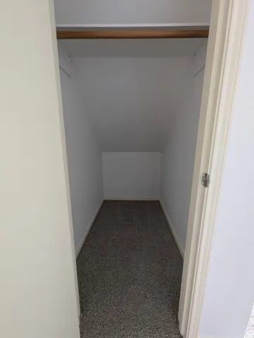 a view of an empty room and a window