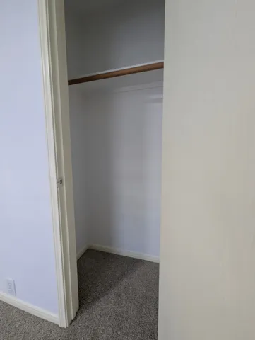 a view of an empty room and a window