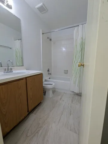 an empty room with windows and cabinet