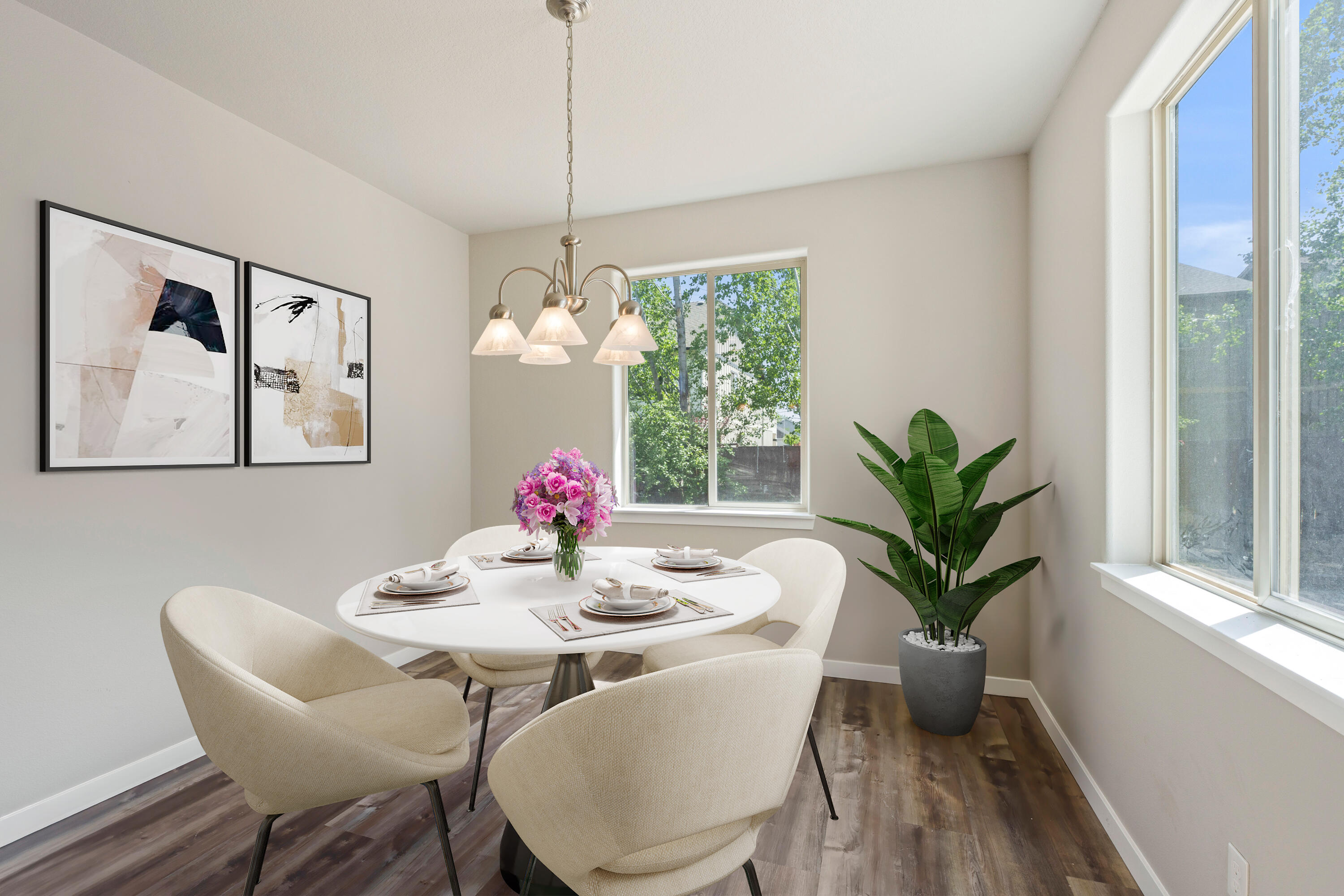 21189 Ritz Place Bend, OR 97702 - Photo 16 of 37 a dining room with furniture potted plants and wooden floor