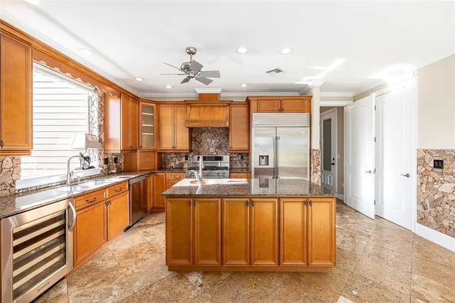 a view of a white house with a big yard and potted plants in front of house