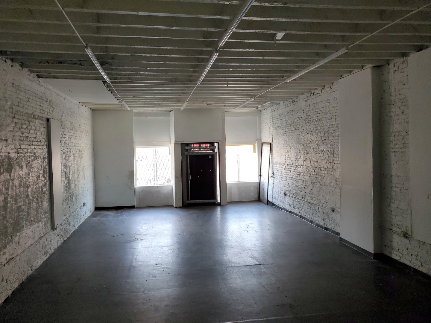 937 West 59th Street Chicago, IL 60621 - Photo 3 of 11 an empty room with wooden floor and windows