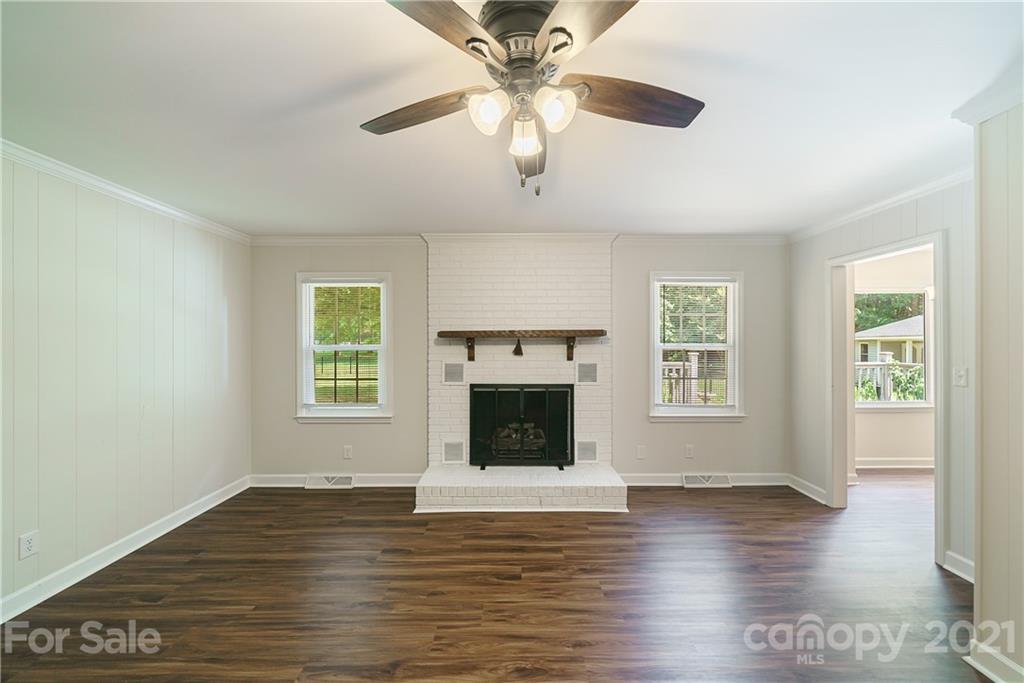 3340 Dan Hood Road Matthews, NC 28105 - Photo 11 of 48 a view of an empty room with wooden floor fireplace and a window