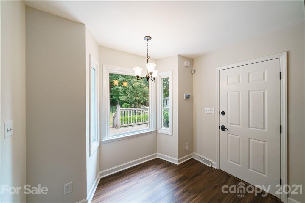 3340 Dan Hood Road Matthews, NC 28105 - Photo 13 of 48 a view of an empty room with wooden floor and a window