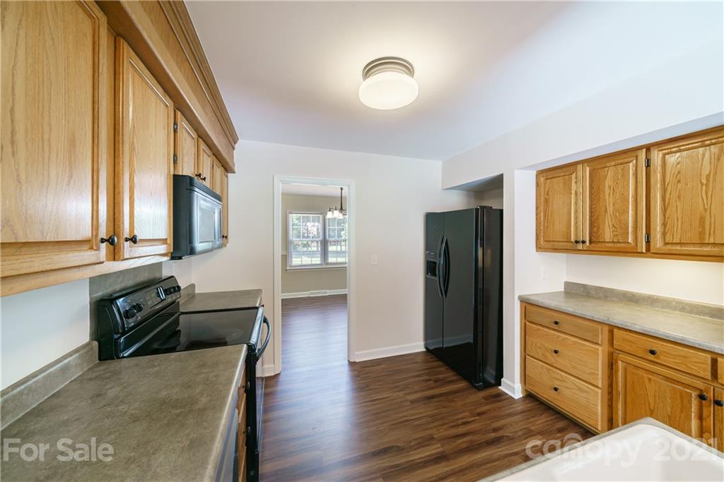 3340 Dan Hood Road Matthews, NC 28105 - Photo 15 of 48 a large kitchen with a refrigerator and wooden floor