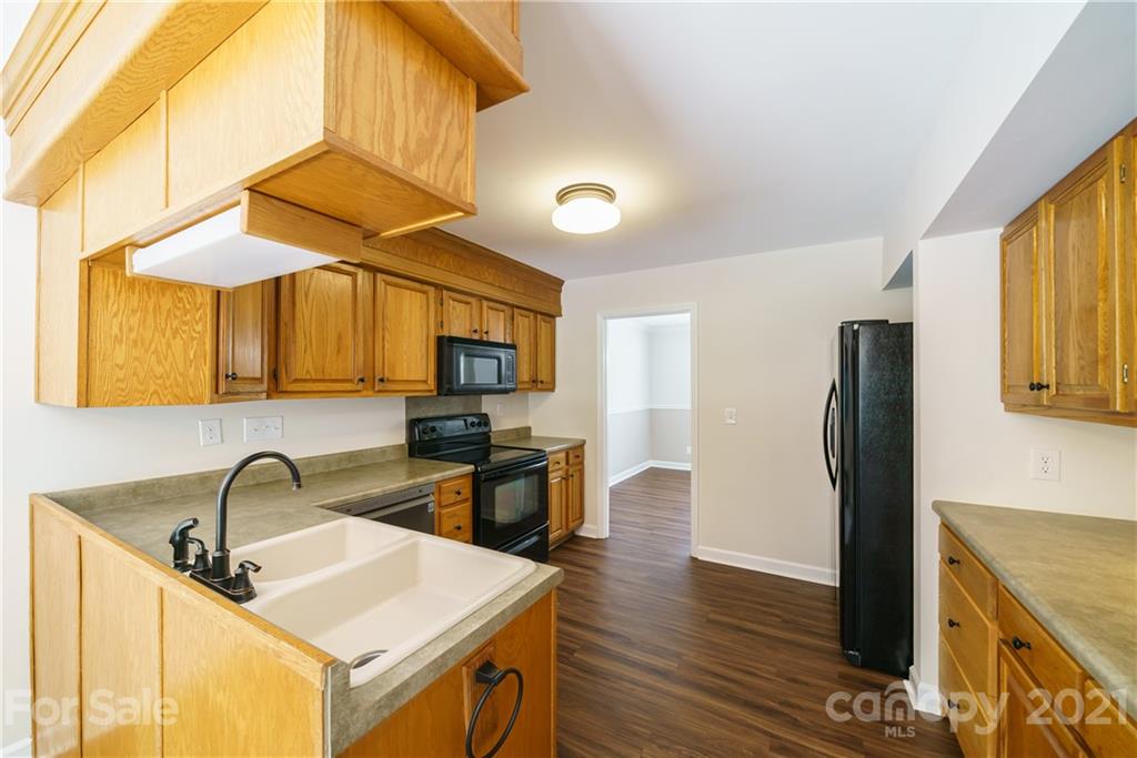 3340 Dan Hood Road Matthews, NC 28105 - Photo 16 of 48 a kitchen with stainless steel appliances a sink a stove and a refrigerator