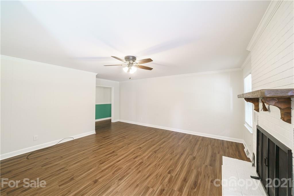 3340 Dan Hood Road Matthews, NC 28105 - Photo 17 of 48 an empty room with wooden floor fan and windows