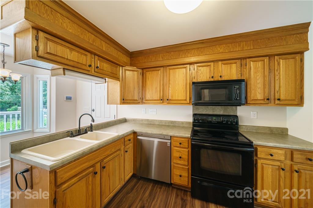 3340 Dan Hood Road Matthews, NC 28105 - Photo 18 of 48 a kitchen with a sink stove and microwave