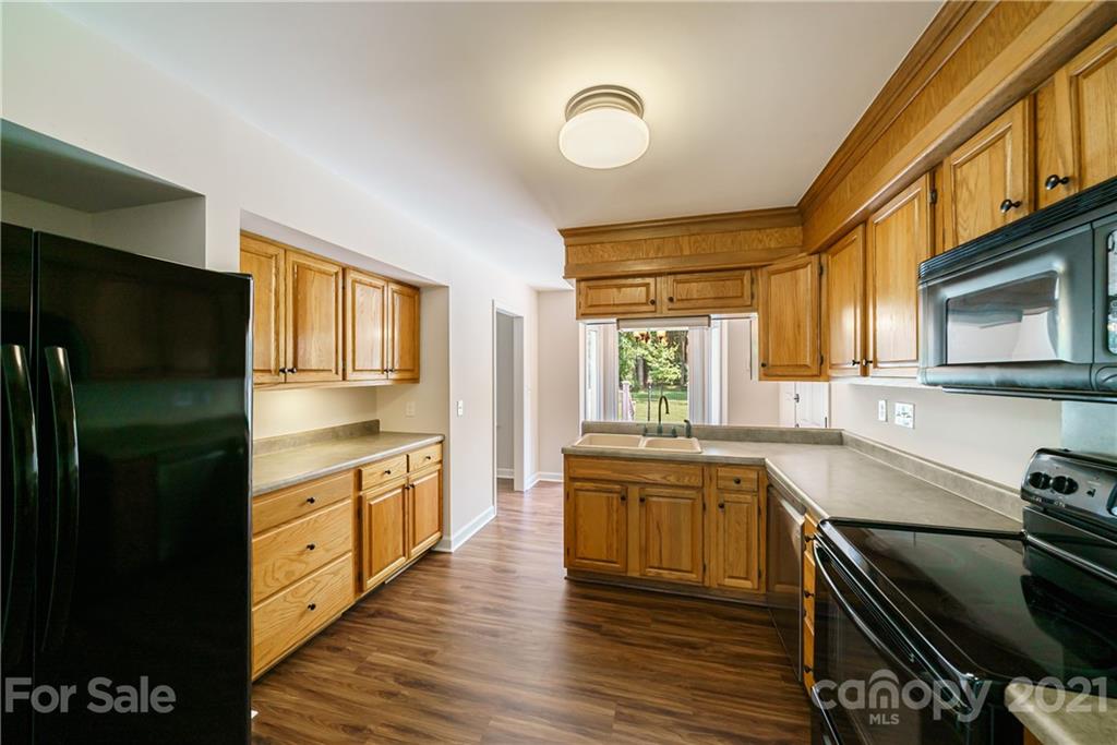 3340 Dan Hood Road Matthews, NC 28105 - Photo 20 of 48 a kitchen with stainless steel appliances granite countertop a stove and a refrigerator