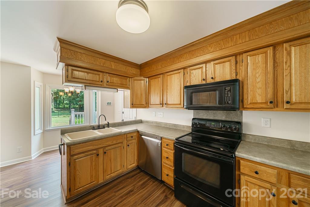 3340 Dan Hood Road Matthews, NC 28105 - Photo 21 of 48 a kitchen that has a sink and a stove