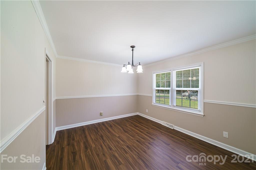 3340 Dan Hood Road Matthews, NC 28105 - Photo 24 of 48 an empty room with wooden floor and windows