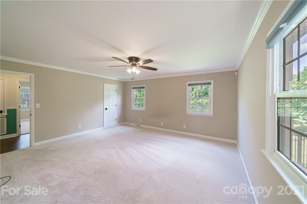 3340 Dan Hood Road Matthews, NC 28105 - Photo 34 of 48 an empty room with windows and chandelier fan