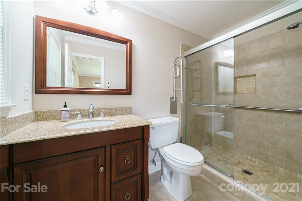 3340 Dan Hood Road Matthews, NC 28105 - Photo 35 of 48 a bathroom with a granite countertop toilet sink shower and mirror