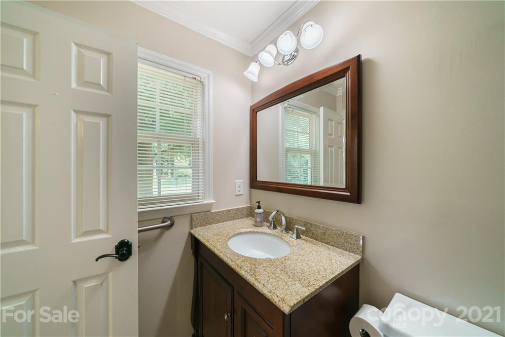 3340 Dan Hood Road Matthews, NC 28105 - Photo 37 of 48 a bathroom with a granite countertop sink and a mirror