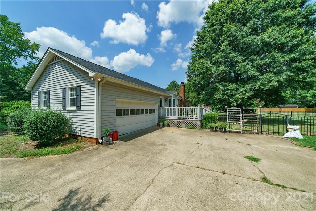 3340 Dan Hood Road Matthews, NC 28105 - Photo 5 of 48 a view of a house with a backyard and bushes
