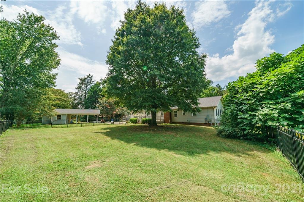 3340 Dan Hood Road Matthews, NC 28105 - Photo 41 of 48 a view of a house with a big yard and large trees