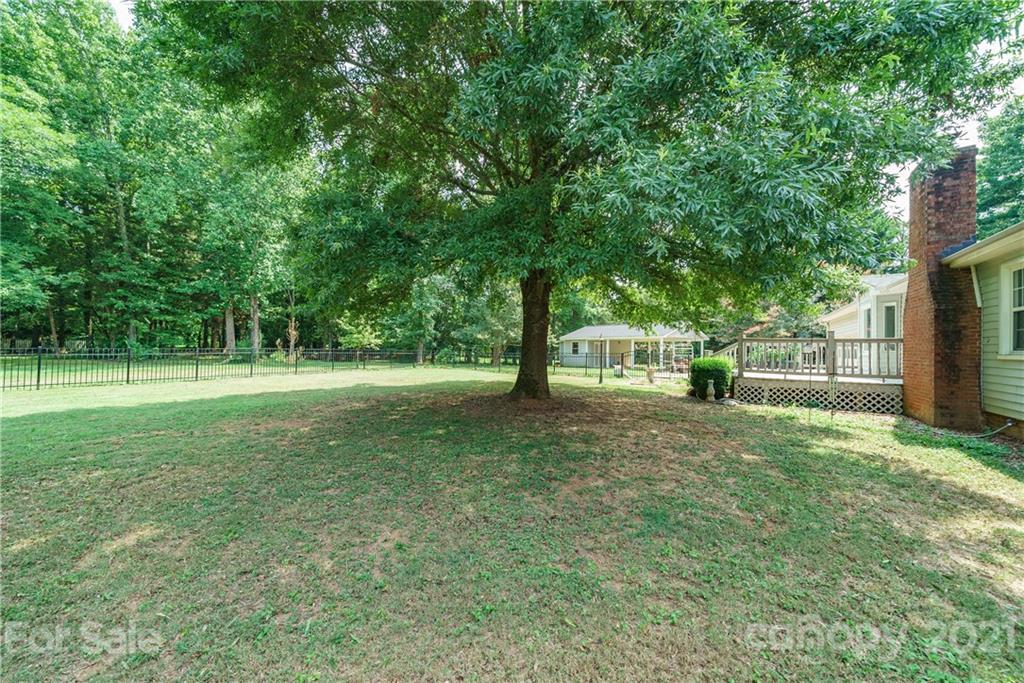 3340 Dan Hood Road Matthews, NC 28105 - Photo 42 of 48 a view of green field with trees in the background