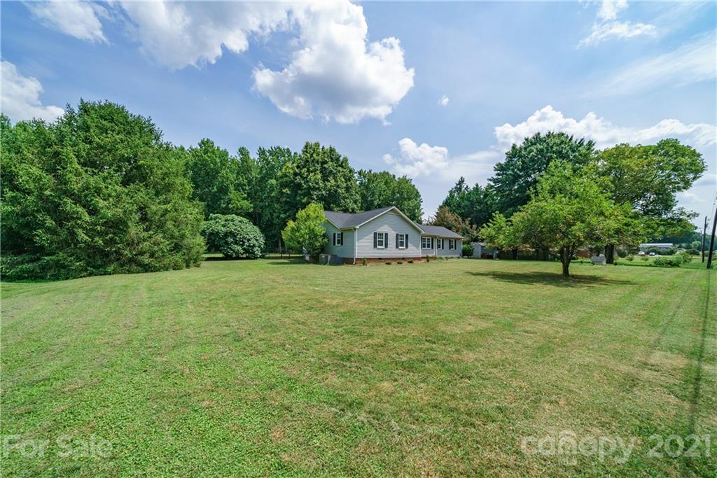 3340 Dan Hood Road Matthews, NC 28105 - Photo 43 of 48 a view of a field of grass and trees