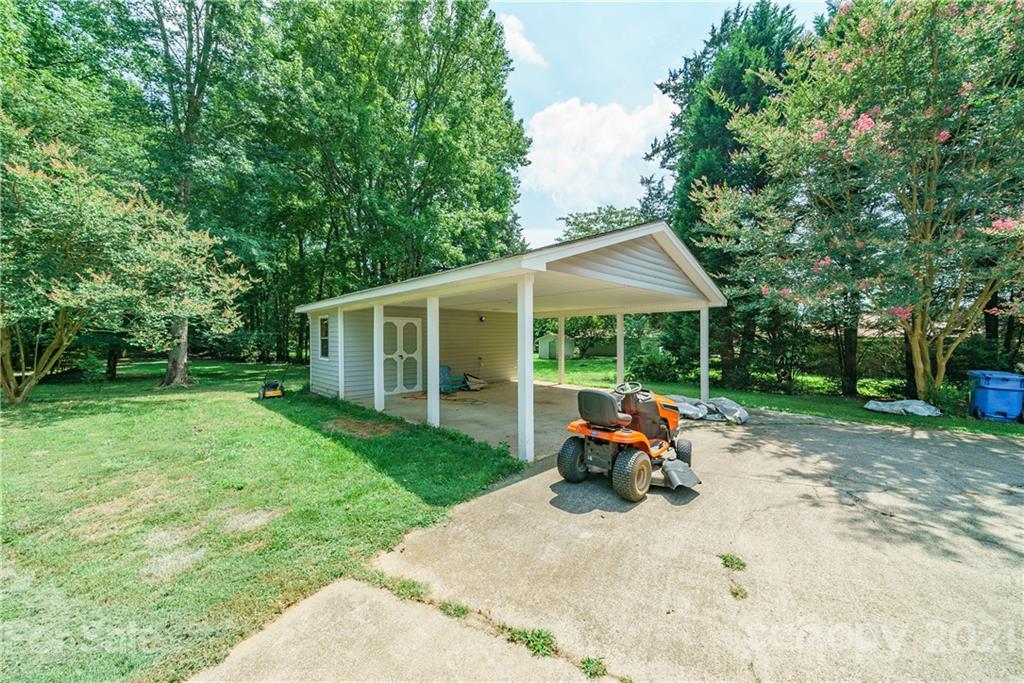 3340 Dan Hood Road Matthews, NC 28105 - Photo 6 of 48 a car parked in front of house with a yard