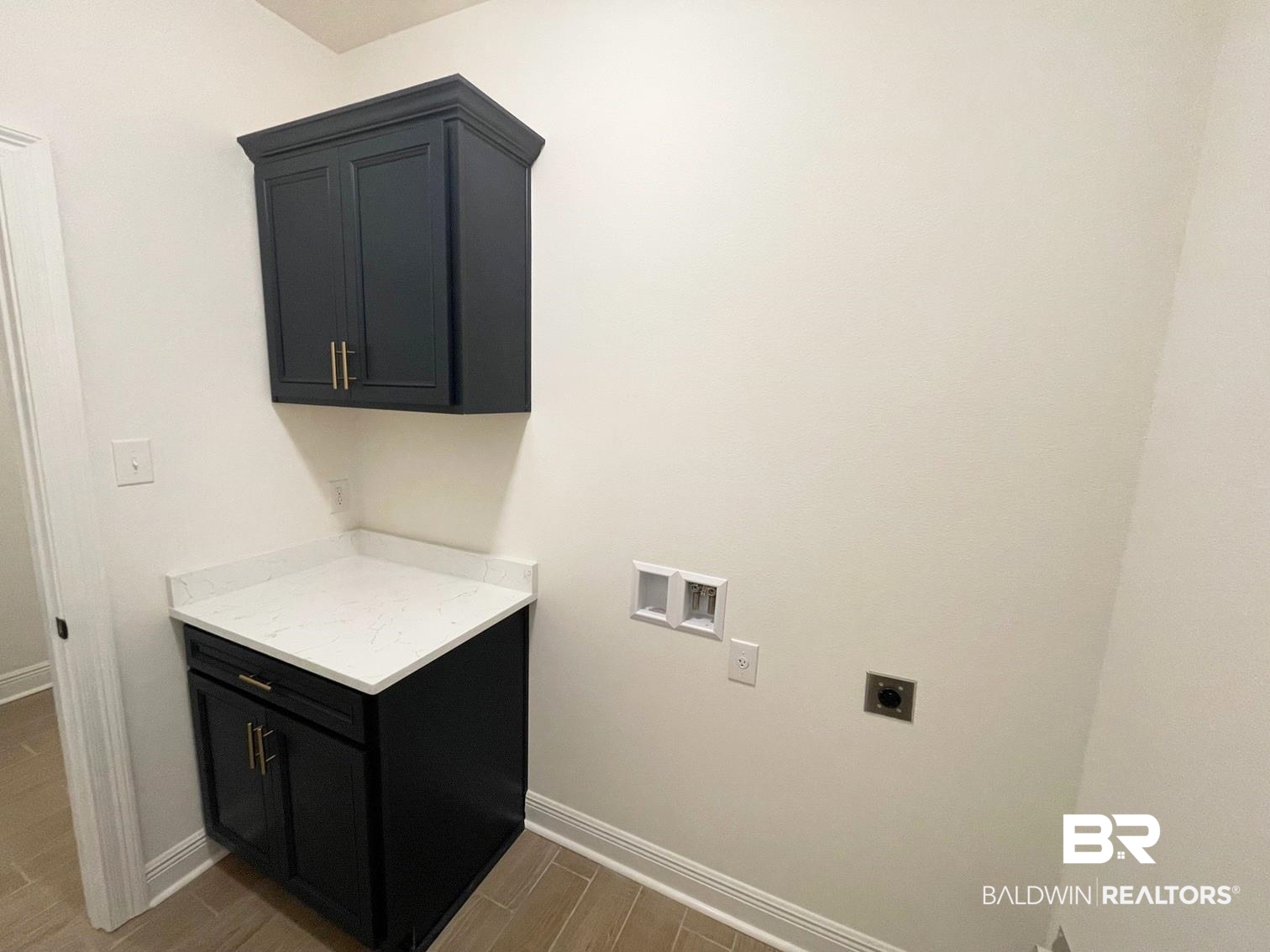 1363 Fenton Circle Foley, AL 36535 - Photo 15 of 20 Clothes washing area featuring electric dryer hookup, hookup for a washing machine, hardwood / wood-style floors, and cabinets