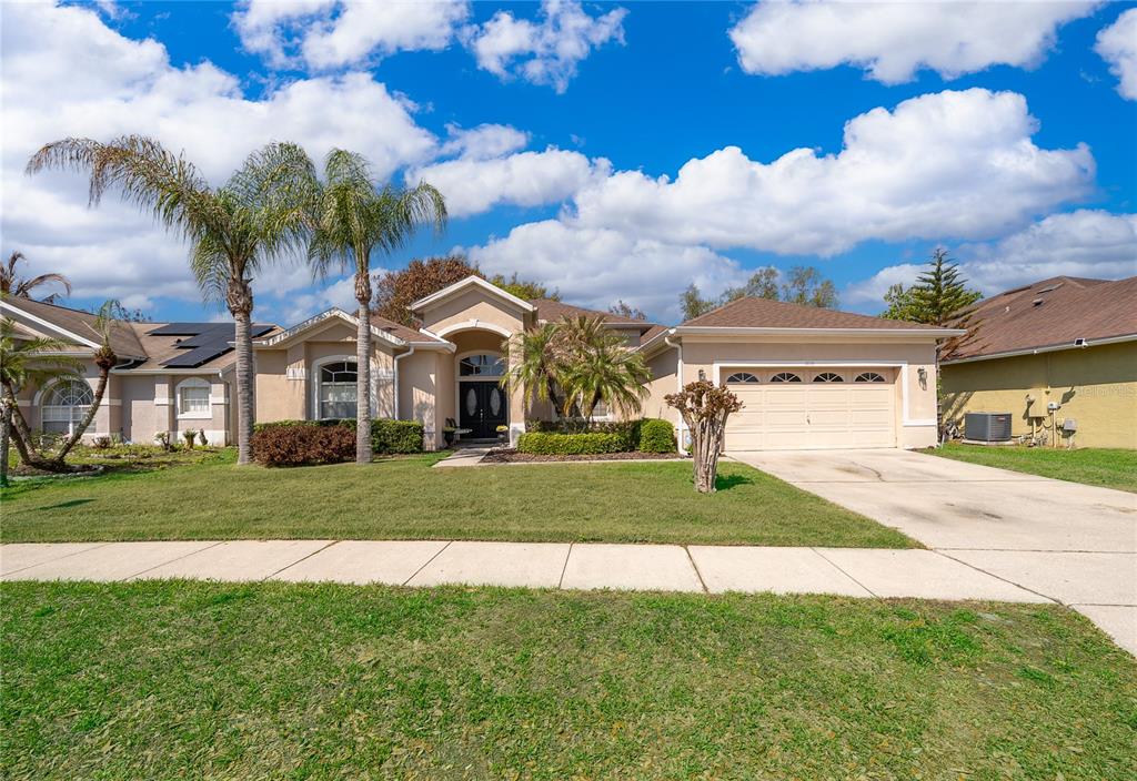 1114 Bridgeway Boulevard Orlando, FL 32828 - Photo 1 of 1 a view of a white house next to a yard with big trees