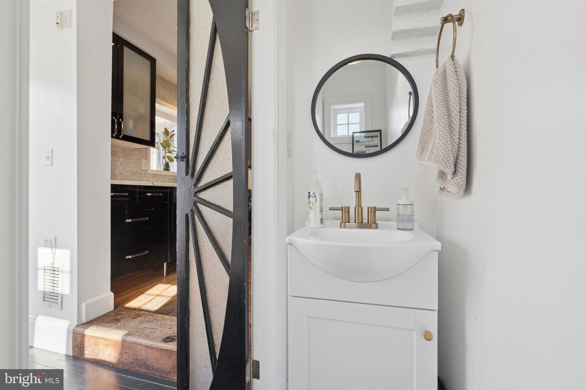 2936 Poplar Street Philadelphia, PA 19130 - Photo 14 of 27 a bathroom with a sink a mirror and a shower