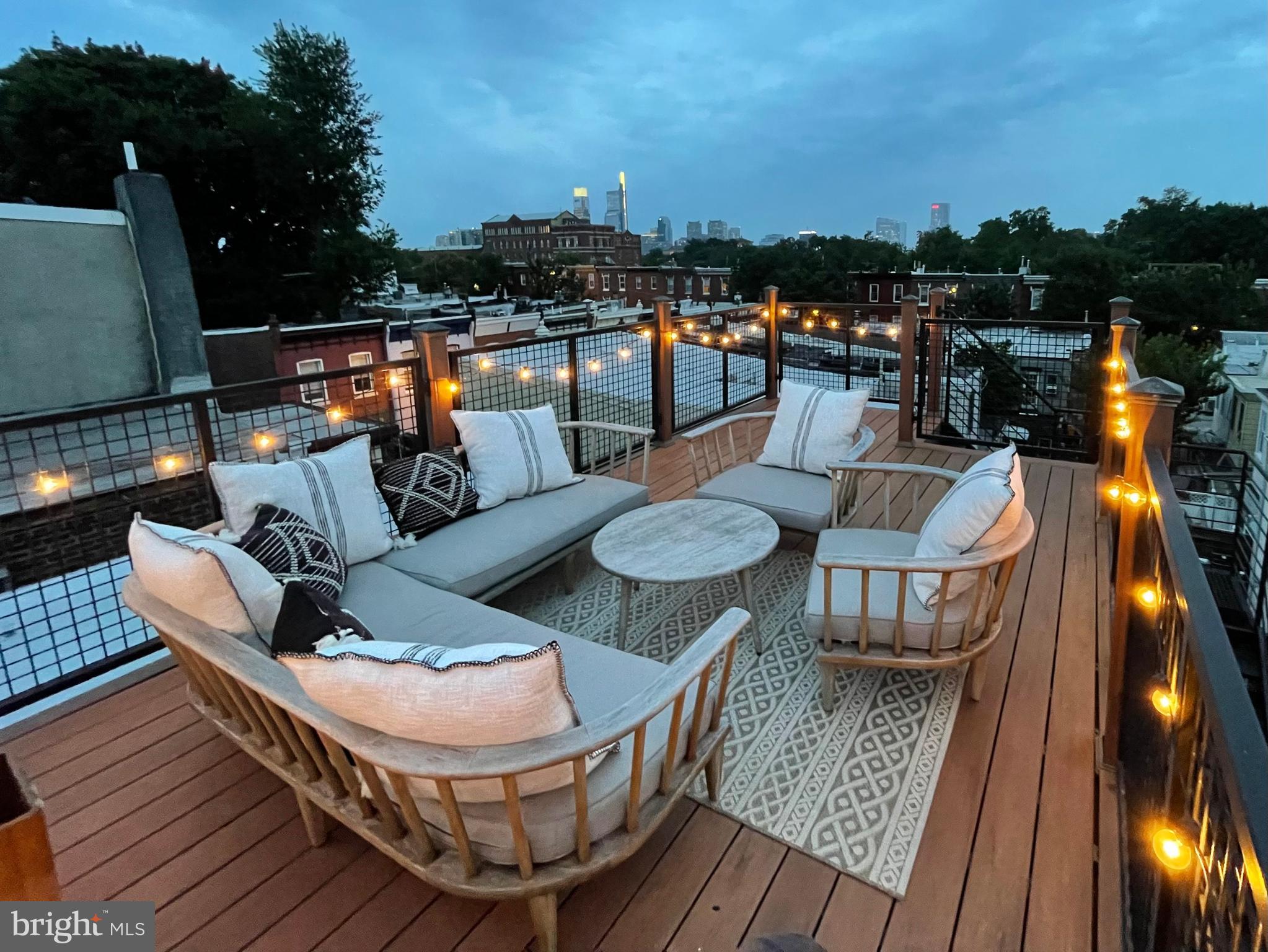 2936 Poplar Street Philadelphia, PA 19130 - Photo 26 of 27 a view of a roof deck with dining table and chairs with wooden floor and fence