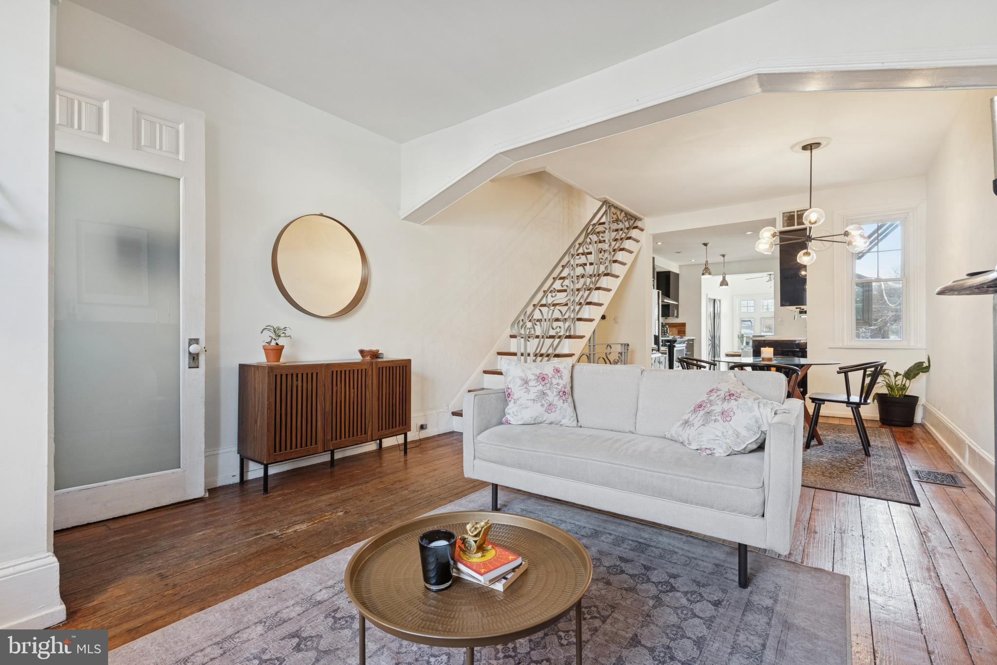 2936 Poplar Street Philadelphia, PA 19130 - Photo 5 of 27 a living room with furniture a lamp a rug and a chandelier