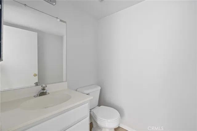 a white toilet sitting next to a bathroom sink