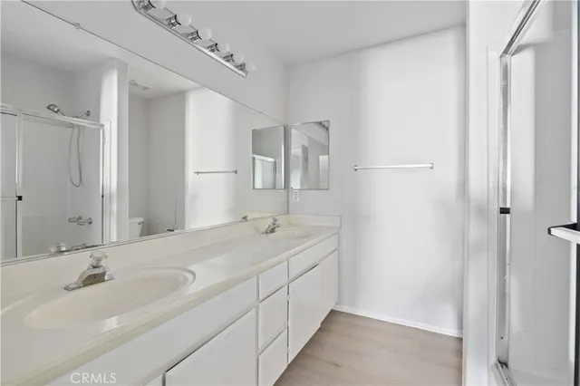 a bathroom with a double vanity sink and mirror