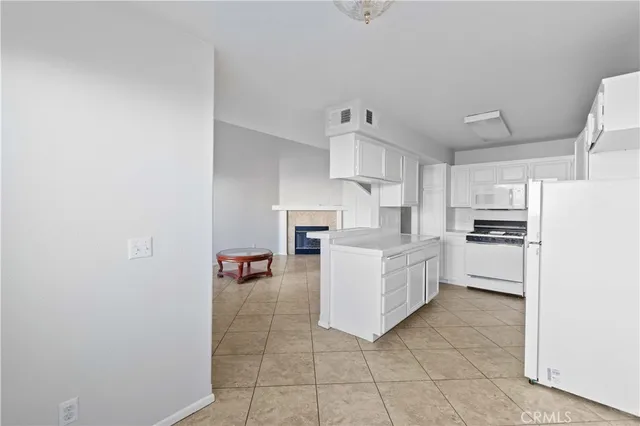 a kitchen with white cabinets and white appliances