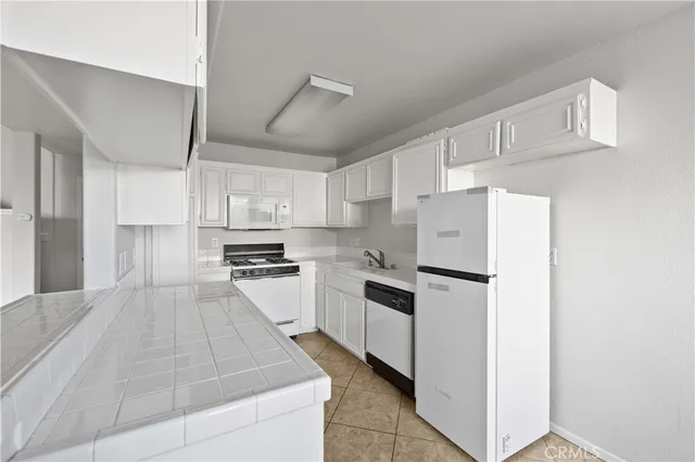 a kitchen with cabinets and white appliances
