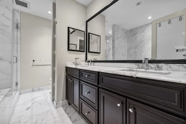 a bathroom with a sink double vanity and a mirror