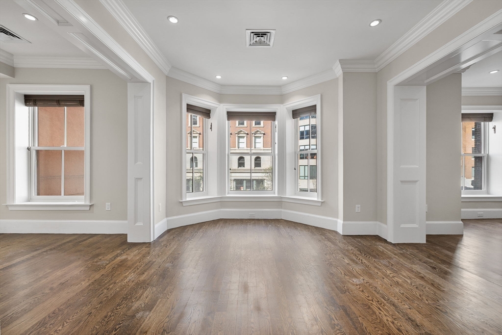 410 Boylston Street, Unit 3 Boston, MA 02116 - Photo 14 of 20 a view of an empty room with wooden floor and a window