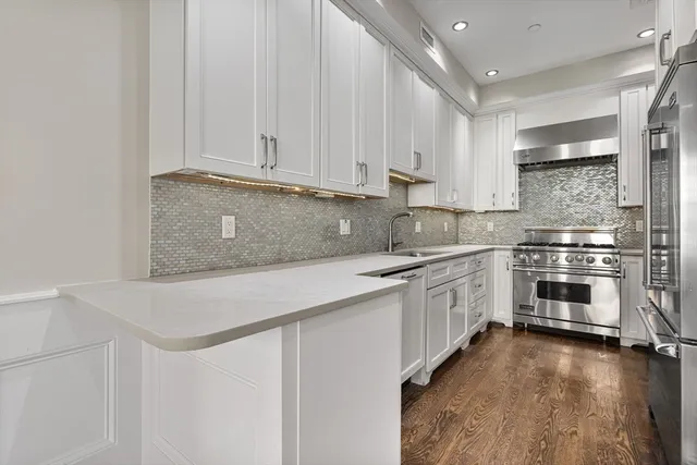 a kitchen with granite countertop white cabinets and white appliances