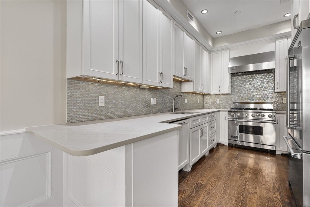 410 Boylston Street, Unit 3 Boston, MA 02116 - Photo 15 of 20 a kitchen with granite countertop white cabinets and white appliances