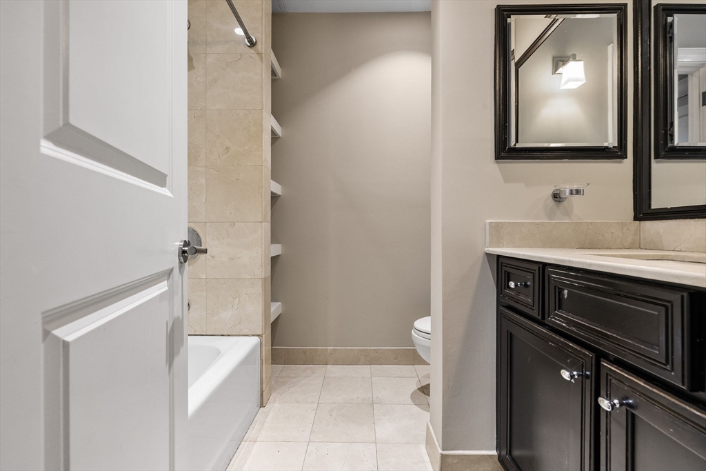 410 Boylston Street, Unit 3 Boston, MA 02116 - Photo 6 of 20 a bathroom with a sink a mirror and a toilet