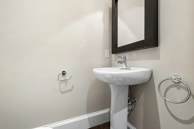 a bathroom with a sink a toilet and a mirror