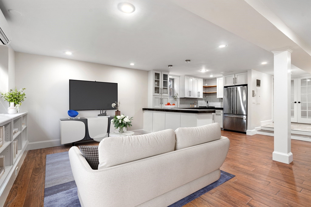 5 Albemarle Street, Unit 1 Boston, MA 02115 - Photo 2 of 5 a living room with furniture and a flat screen tv