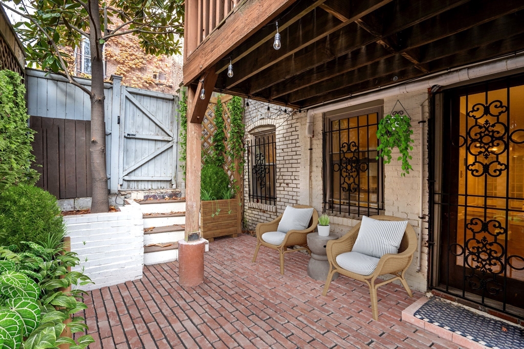 5 Albemarle Street, Unit 1 Boston, MA 02115 - Photo 3 of 5 a view of patio with a table and chairs and wooden floor