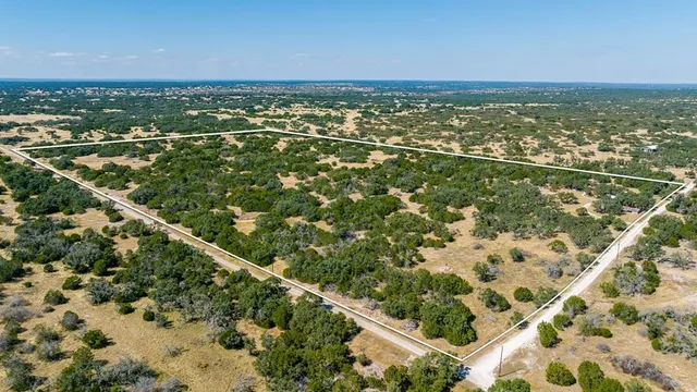 an aerial view of residential houses with city view