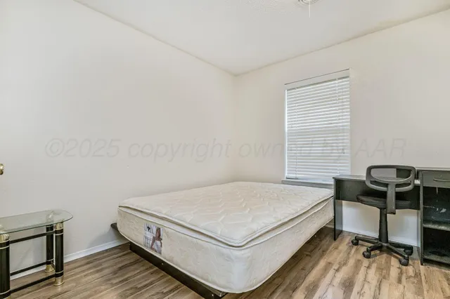 a bed sitting in a room next to a window