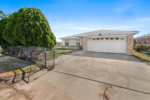 a view of a house with a yard and garage