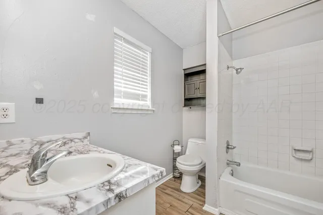 a bathroom with a bathtub and a toilet