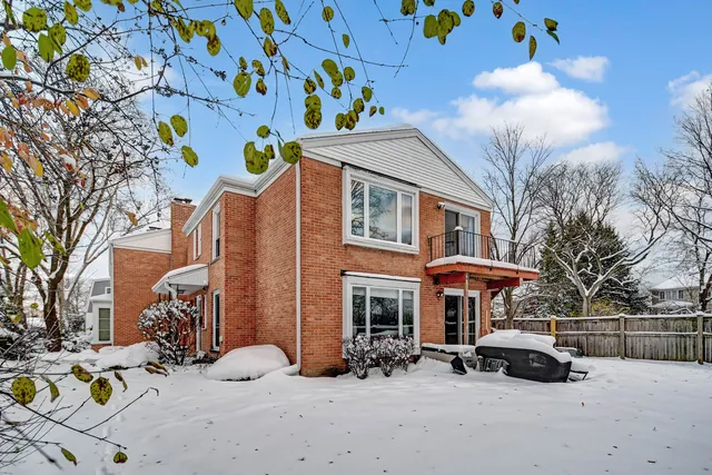 a view of a house with a yard covered in snow